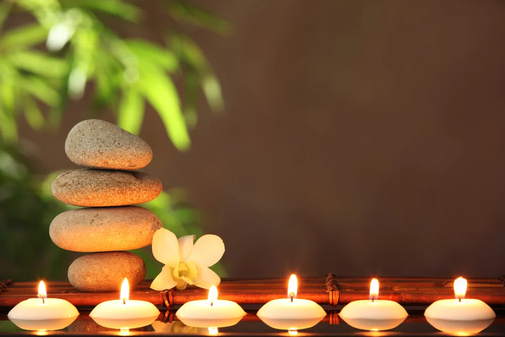 Spa candles and stones with calming background music